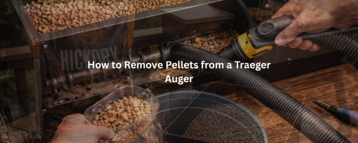 Hands vacuum pellets from Traeger auger to clean pellet grill hopper