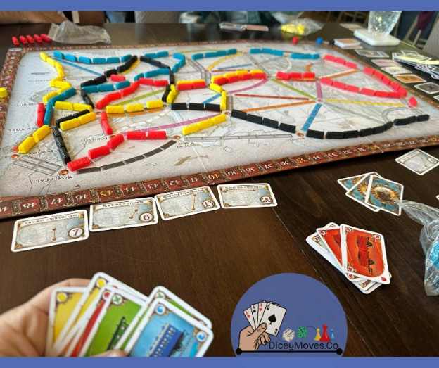 a game of ticket to ride almost finished with a board full of train routes and some remaining cards in hand