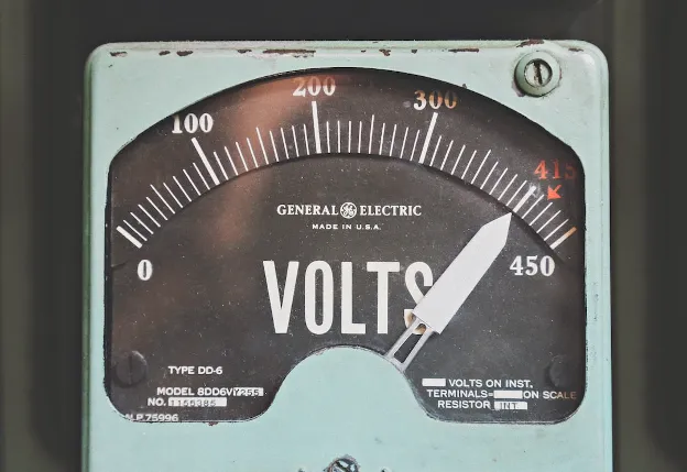  Old analog voltmeter used to test battery voltage—important step in checking RV batteries after winter storage.