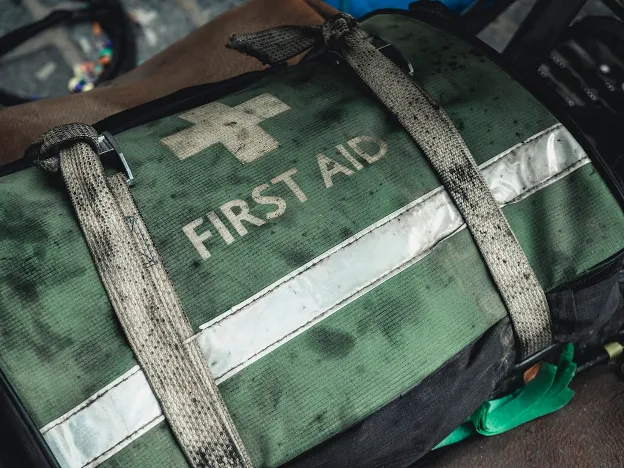  Worn, green first aid kit with straps—indicates checking and restocking RV emergency and first aid supplies.