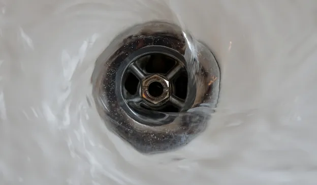  Clean water draining from a sink—representing flushing the RV fresh water system as part of the de-winterization process.