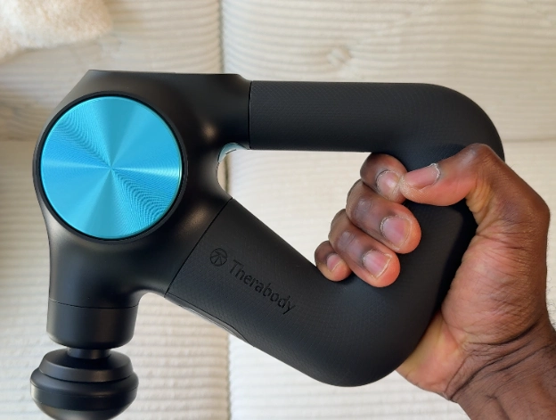 Person firmly gripping the Theragun PRO Plus to show ergonomic handle design.