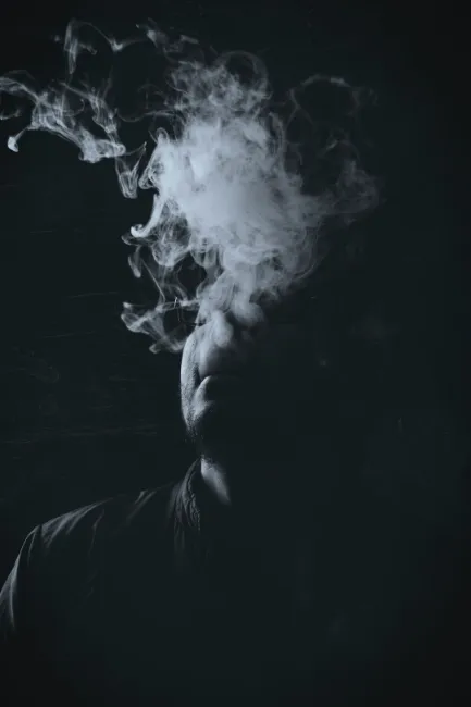 person in the dark vaping 