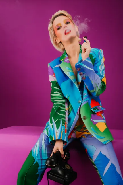 woman in colorful outfit vaping  