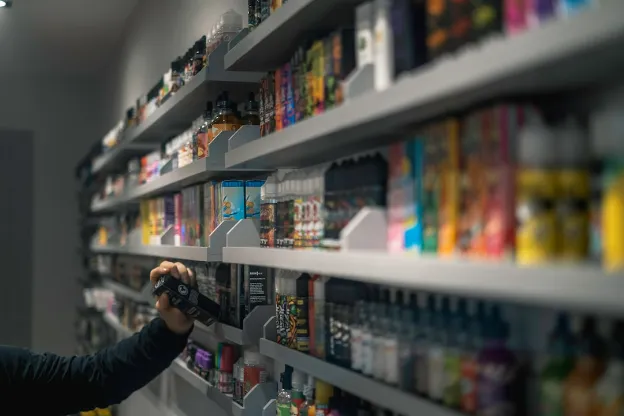 shelves with e-cigarettes liquid