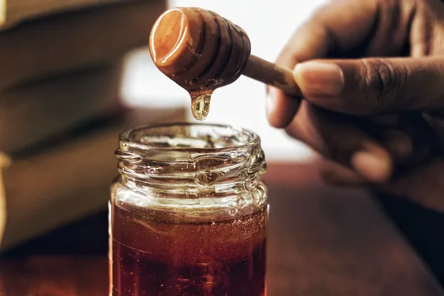 getting honey from a jar