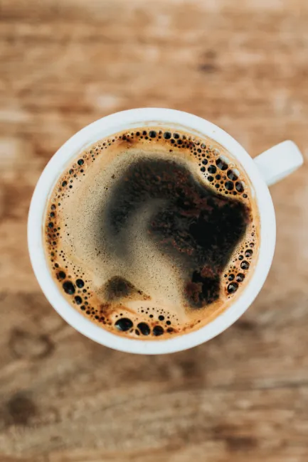 looking down on a cup of black coffee
