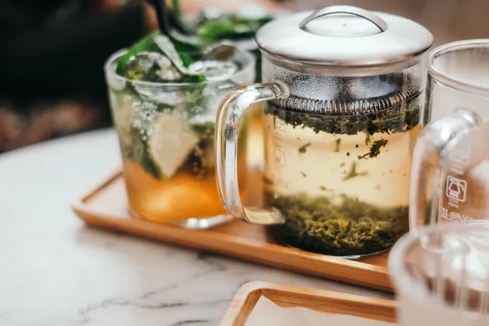 loose leaf tea steeping in glass mug