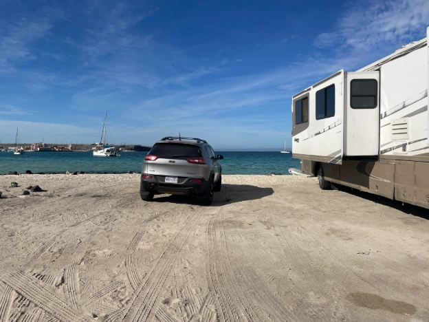 Image of a class A rv parked on the beah in mexico