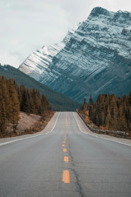 image of a long road leading to the mountains