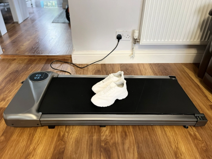 Walking pad for home office use on wooden floor, showing walking pad benefits and whether a walking pad is worth it