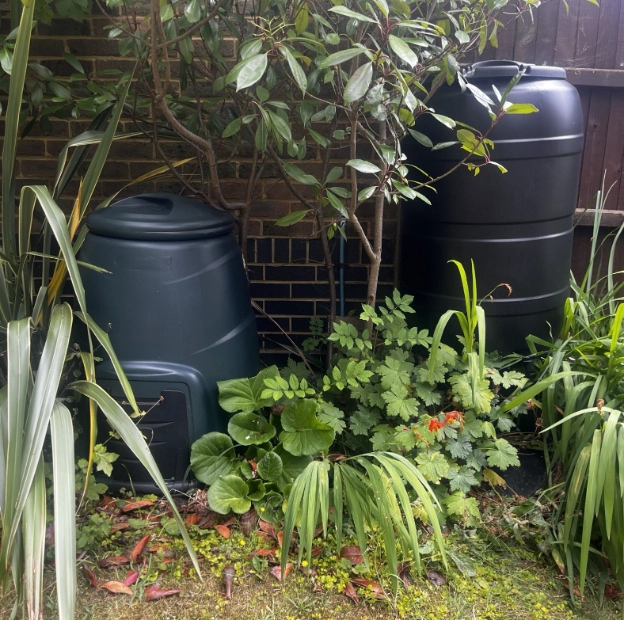 Compost bin and water butt in my garden to reduce waste and offset ChatGPT use as a Virtual Assistant.
