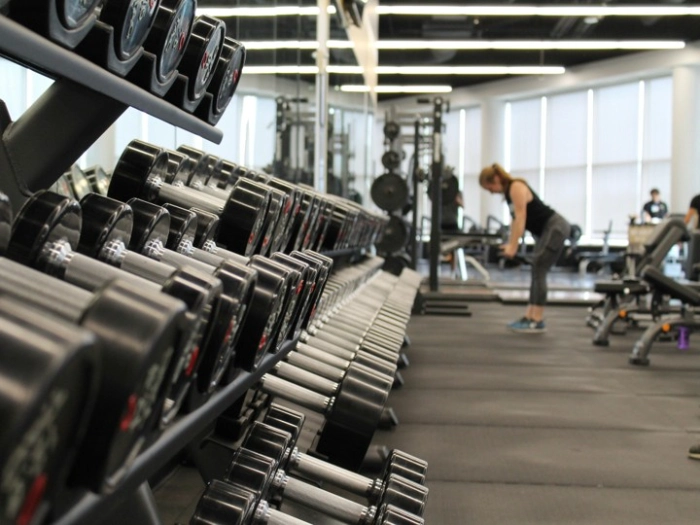 Free weights and gym equipment inside a modern gym