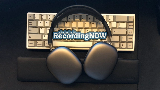 AirPods Max headphones laying on computer keyboard