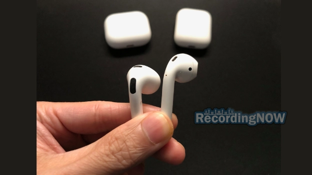 Holding Apple AirPods 3rd gen vs 2nd gen earbuds in hand