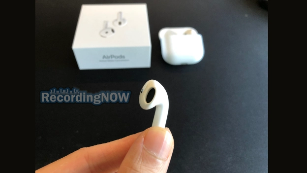 Holding AirPods 4th gen with Active Noise Cancellation earbud