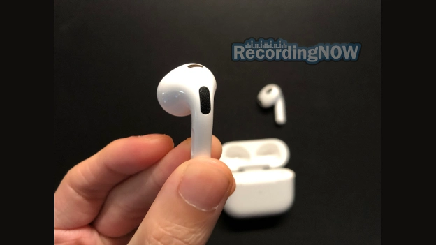 Holding the left Apple AirPods 3rd gen earbud in hand