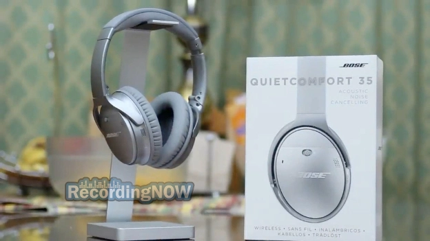 Bose QuietComfort 35 II in silver on headphone stand next to box