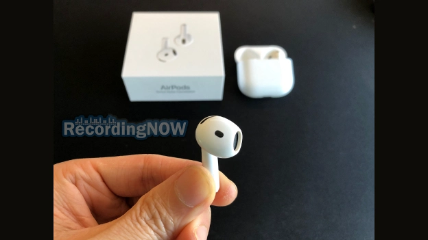 Holding left AirPods 4th generation with ANC earbud in hand