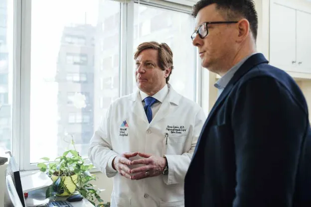 two men standing inside a room