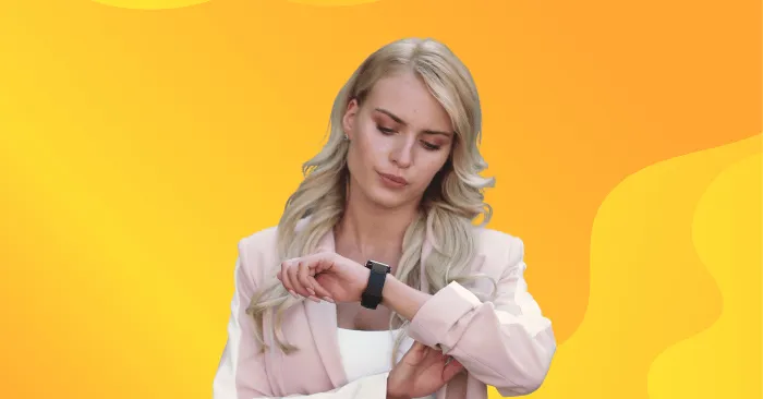 Image of a woman looking at her smartwatch with yellow background