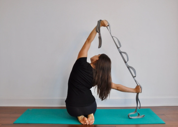 A woman stretching and doing cycle syncing workouts.